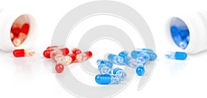 Red and blue medical capsules. Pills on white background