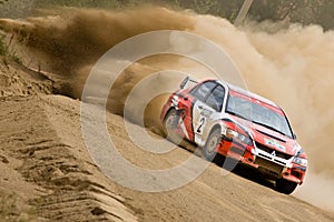 Red and blue Mitsubishi Lancer at rally