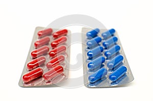 Red and blue pills in blister packaging isolated on white background