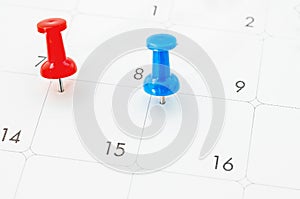 Red and blue pin on White Calendar.