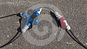 Red and Blue Professional industrial grade Electrical power extension cable on the ground