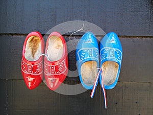 The Red and blue traditional Dutch wooden clogs hanging on the wall in Zaanse Schans, the Netherlands.