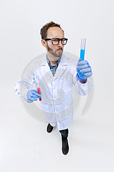 High angle view of young chemist, doctor conducts chemical research isolated on white background. Concept of