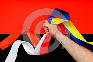 Red blue white yellow black conflict between Ukraine Poland two flag top view hand right sector confrontation