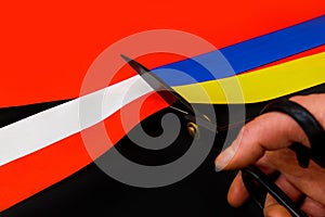 Red blue white yellow black conflict between Ukraine Poland two flag top view hand right sector confrontation scissors