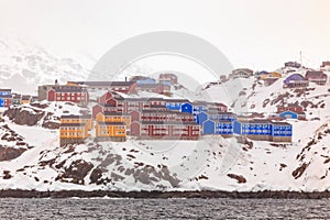 Red, blue and yellow living houses on the rocky hills of Sisimiut the 2nd largest Greenlandic city