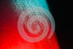 Red and blueish lights on buckram clothes surface