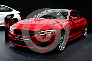 A red BMW M4 car