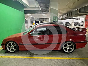 Red BMW M3 E36 parking lot photo