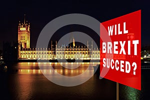 Red board with phrase & x27;Will BREXIT Succed& x27;. Brexit Concept with parliament in background at night. London, UK