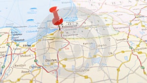 A red board pin stuck in Kaliningrad in a map of Russia photo