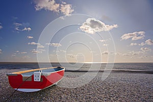 Red boat on beach