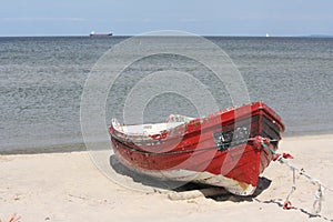 A red boat on a beach