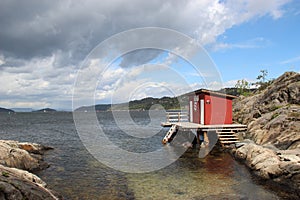 Red boat house at the sea