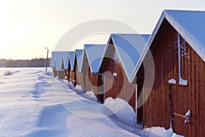 Red Boat Houses on the Frozen Shore in Finland