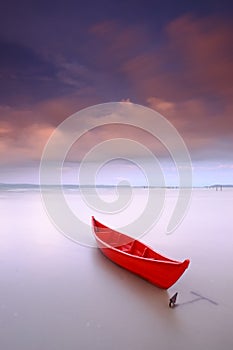 Red boat isolated anchored sunset