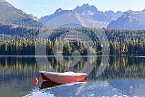 Red boat on mountain lake