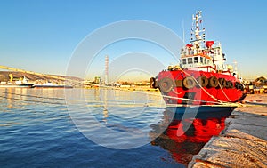 Red boat at the new mole of Drapetsona photo