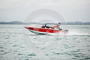 Red boat sailing on the sea. beautiful and fast vessel moves open water.