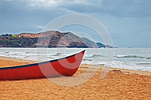 Red boat on a sandy beach