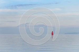 Red boat at sundown at lake Garda, Italy