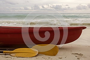 Red boat and yellow paddle