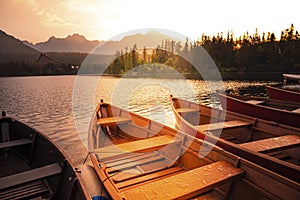 Red boats on Lake Strbske pleso. Morning view of the High Tatras National Park, Slovakia, Europe.