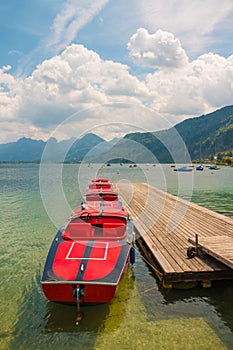 Red boats on mountain lake Wolfgangsee, Austria