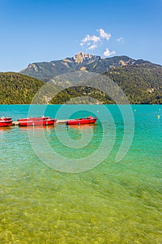 Red boats on a mountain lake Wolfgangsee, St. Gilgen, Austria
