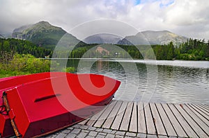 Red boats by Strbske Lake water Tatra mountains