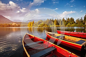 Red Boats on the water glowing in sunlight at sunset