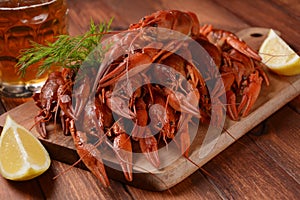 Red boiled crawfishes on table in rustic style.