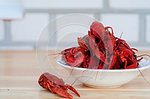Red boiled crayfish in a white bowl