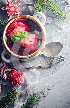 Red borscht dumplings Christmas table place text cutlery