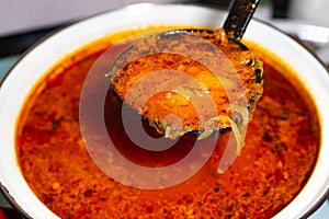 Red borscht in a pot on the stove. Russian and Ukrainian soup