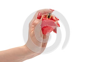 Red bottle of perfume in woman hand with red nails isolated on a white background