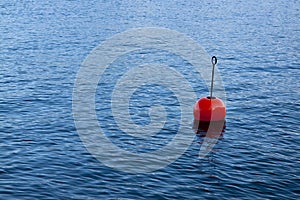 Red bouy on a calm lake