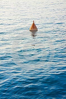 Red bouy on a calm lake - concept image with copy space