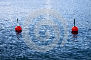 Red bouy on a calm lake isolated on blue background