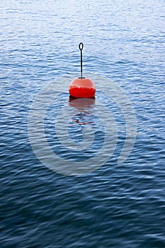 Red bouy on a calm lake