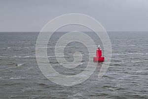 Red bouy floating in sea