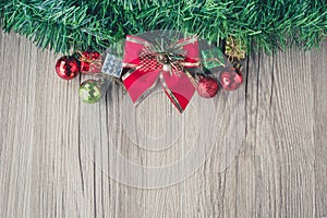 Red bow christmas gift boxes and balls background on wooden texture