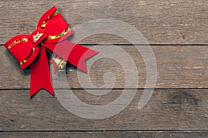 Red bow christmas on wood background with copyspace