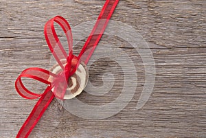 Red bow with cookies on wood