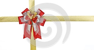 Red bow with gold ribbon on gift box