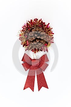 Red bow with pinecone flower over tinsel christmas decoration isolated. Xmas