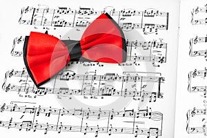 Red bow tie on music sheet