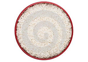 Red bowl of raw organic basmati rice on white background. Healthy food. Top view