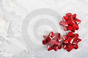 Red bows on grey background with copy space