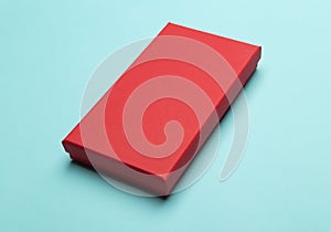 Red box product packaging isolated on blue background.
